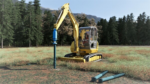 An electric excavator screws a foundation screw into the ground.